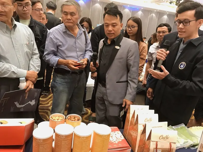 John presenting packaged food products to visitors at a trade showcase